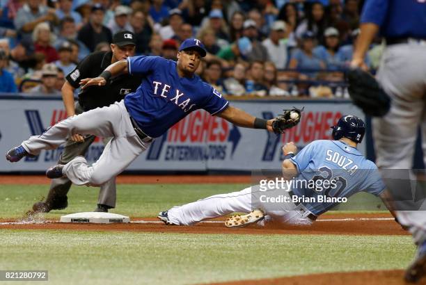 Steven Souza Jr. #20 of the Tampa Bay Rays steals third base ahead of third baseman Adrian Beltre of the Texas Rangers during the fourth inning of a...