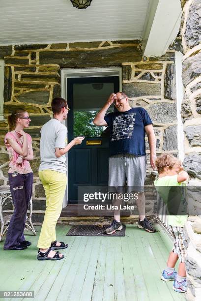 MoveOn.org members talk with neighbor during the Neighborhood Listening Project Healthcare Door Knocking Canvass Event on July 23, 2017 in Ardmore,...