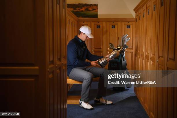 Jordan Spieth of the United States holds the Claret Jug in the locker room after winning the 146th Open Championship at Royal Birkdale on July 23,...