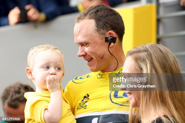 Chris Froome of Great Britain and Team Sky with his son, Kellan and wife Michelle on the podium after winning the yellow jersey during stage twenty...