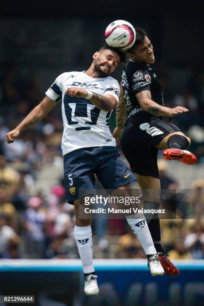Alan Mendoza of Pumas struggles for the ball with Edson Puch of Pachuca during the 1st round match between Pumas UNAM and Pachuca as part of the...