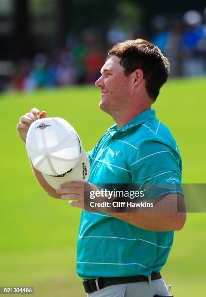 Grayson Murray of the United States celebrates after winning on the 18th green during the final round of the Barbasol Championship at the Robert...