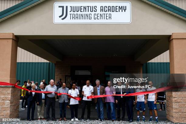 Juventus legends Edgar Davids and David Trezeguet pose with local dignitaries, staff and youth soccer players for a ribbon cutting at the Juventus...