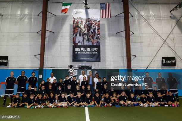 Juventus legends Edgar Davids and David Trezeguet pose with staff and youth soccer players at the Juventus Academy USA launch event on July 23, 2017...