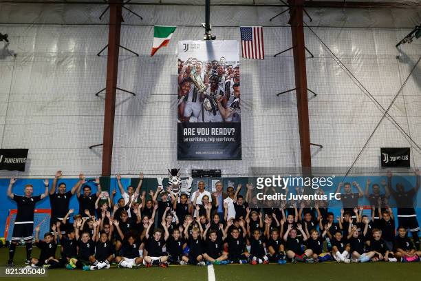 Juventus legends Edgar Davids and David Trezeguet pose with staff and youth soccer players at the Juventus Academy USA launch event on July 23, 2017...