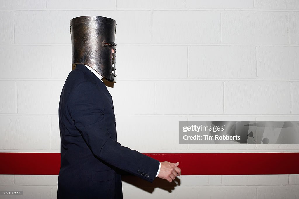 Businessman wearing helmet and walking