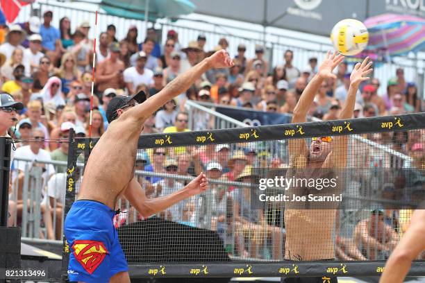 Sean Rosenthal spikes the ball past Jake Gibb during the men's final of the AVP Hermosa Beach Open on July 23, 2017 in Hermosa Beach, California.