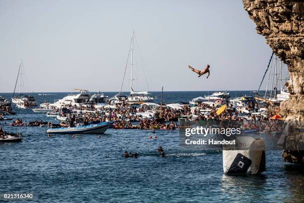 In this handout image provided by Red Bull, Artem Silchenko of Russia dives from the 27 platform during the third stop of the Red Bull Cliff Diving...