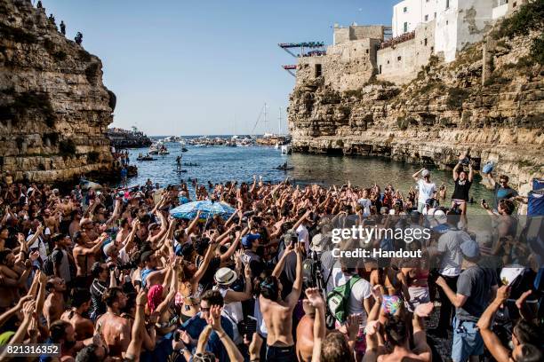 In this handout image provided by Red Bull, Alessandro De Rose of Italy celebrates his win on the podium alongside David Colturi and Andy Jones of...