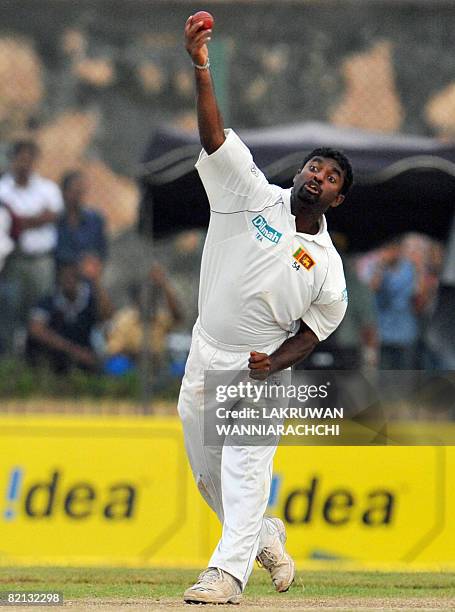 Sri Lankan cricketer Muttiah Muralitharan delivers a ball during the first day of the second Test match between India and Sri Lanka at The Galle...