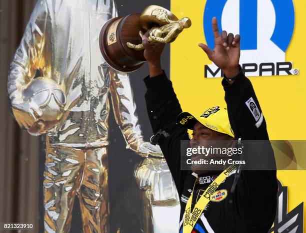Top fuel driver Antron Brown celebrates with fans after winning the 38th annual NHRA Mopar Mile High Nationals at Bandimere Speedway July 23, 2017.