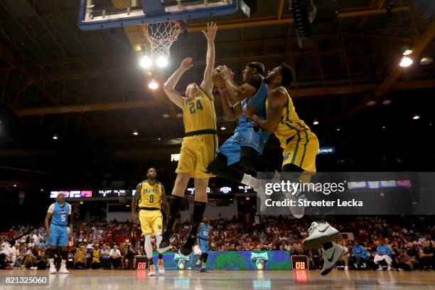 Jerome Williams of Power attempts a shot between Brian Scalabrine and Xavier Silas of the Ball Hogs during week five of the BIG3 three on three...