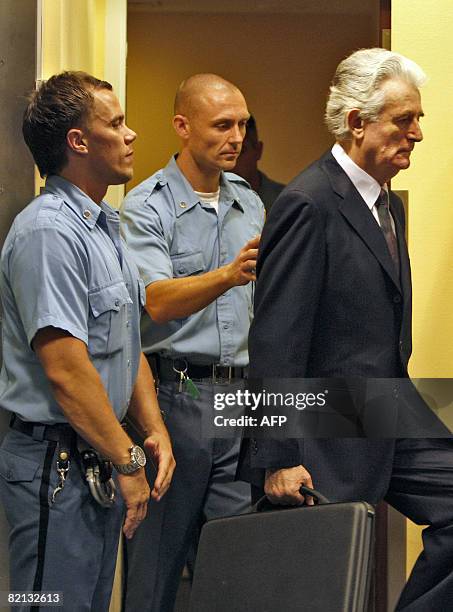 Former Bosnian Serb leader Radovan Karadzic enters the court room of the International Criminal Tribunal for the Former Yugoslavia at the start of...