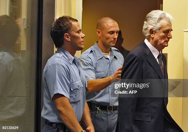 Former Bosnian Serb leader Radovan Karadzic enters the court room of the International Criminal Tribunal for the Former Yugoslavia at the start of...