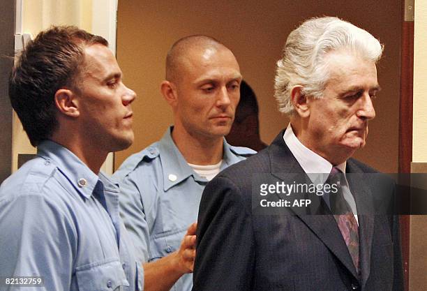 Former Bosnian Serb leader Radovan Karadzic enters the court room of the International Criminal Tribunal for the Former Yugoslavia at the start of...