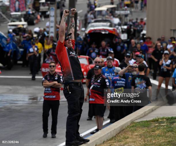 Pros stock motorcycle rider Eddie Krawiec's crew celebrates his victory on the line at the 38th annual NHRA Mopar Mile High Nationals at Bandimere...