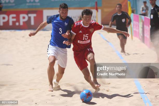 Russia's Romanov vies with France's Soares during the Beach Soccer Mundialito 2017 match between Russia and France at the Carcavelos beach in...