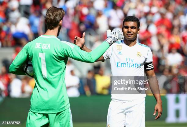 Carlos Henrique Casemiro of Real Madrid congratulates goalie David De Gea of Manchester United after De Gea stopped Casemiro's penalty kick in a...