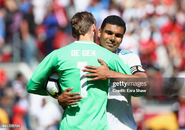 Carlos Henrique Casemiro of Real Madrid congratulates goalie David De Gea of Manchester United after De Gea stopped Casemiro's penalty kick in a...