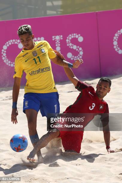 Brazil's forward Mauricinho fights for the ball with Portugal's defender Leo Martins during the Beach Soccer Mundialito 2017 match between Portugal...
