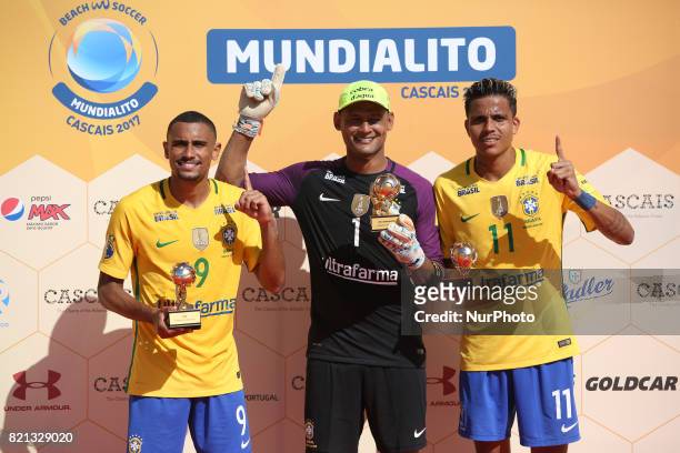 Brazil's forward Rodrigo , Brazil's goalkeeper Mao and Brazil's forward Mauricinho raise their trophies of Most Value Player, Best Goalkeeper and Top...