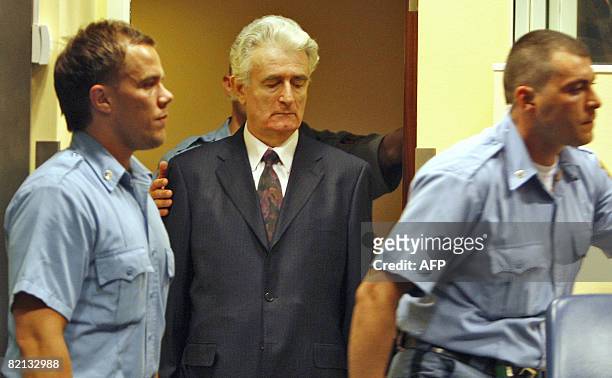 Former Bosnian Serb leader Radovan Karadzic enters the court room of the International Criminal Tribunal for the Former Yugoslavia at the start of...