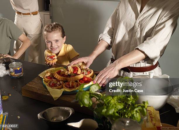 girl holding small cake in family kitchen - cake case stock pictures, royalty-free photos & images