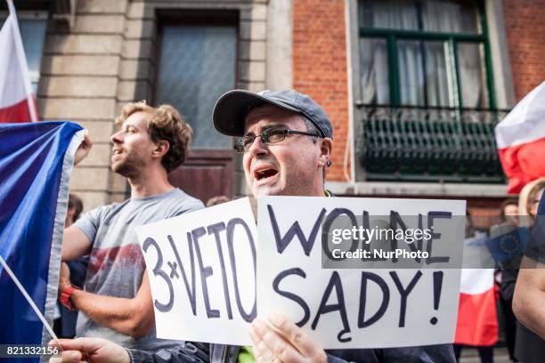 Protester holds a sign that reads 'Wolne Sady' . In opposition to the court reforms in Poland, people protest on July 23, 2017 in Brussels.