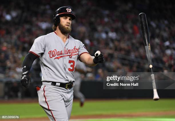 Bryce Harper of the Washington Nationals throws his bat after lining out to center field against the Arizona Diamondbacks during the ninth inning at...