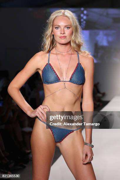 Model walks the runway at SWIMMIAMI Mia Marcelle 2018 Collection at SWIMMIAMI tent on July 23, 2017 in Miami Beach, Florida.