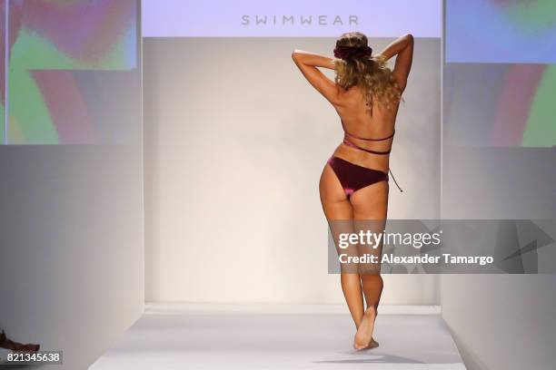 Model walks the runway at SWIMMIAMI Mia Marcelle 2018 Collection at SWIMMIAMI tent on July 23, 2017 in Miami Beach, Florida.