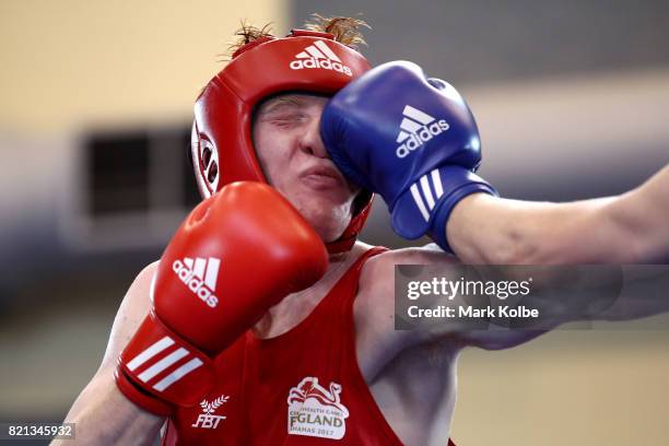 Aaron Bowen of England is punched by Kane Tucker of Northern Ireland as they compete in the Boy's 75 kg Gold Medal bout between Aaron Bowen of...