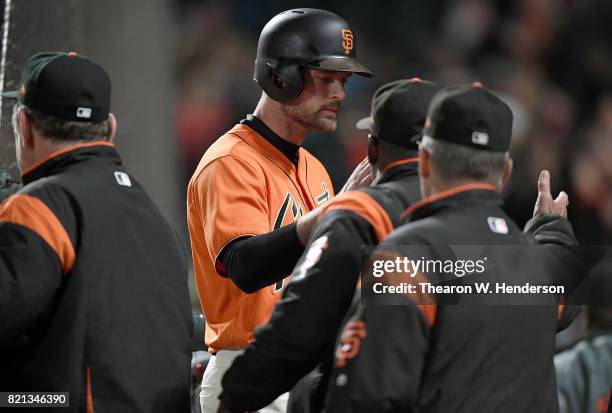 Conor Gillaspie of the San Francisco Giants is congratulated by teammates and coaches after Gillaspie hit a two-run homer against the San Diego...