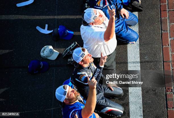 Kasey Kahne, driver of the Farmers Insurance Chevrolet, celebrates with team owner Rick Hendrick and his crew after winning the Monster Energy NASCAR...