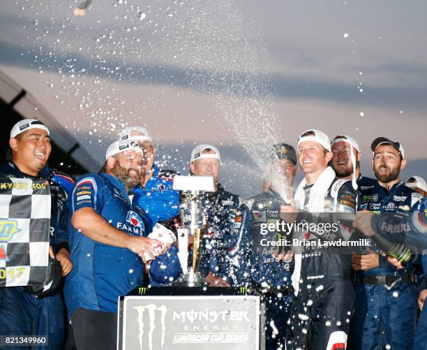 Kasey Kahne, driver of the Farmers Insurance Chevrolet, celebrates with his crew after winning the Monster Energy NASCAR Cup Series Brickyard 400 at...