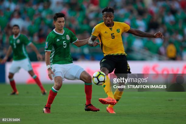 Jesus Molina of Mexico and Alvas Powell of Jamaica compete for the ball during a match between Mexico and Jamaica as part of CONCACAF Gold Cup...