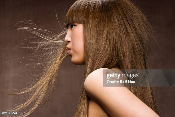 beauty portrait of asian woman blowing hair  - woman long brown hair stock pictures, royalty-free photos & images