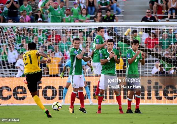 Jermaine Taylor of Jamaica attempts a shot on a free kick around Erick Torres, Jesus Duenas, Jesus Molina and Erick Gutierrez of Mexico during the...