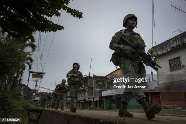 Philippine Marines soldiers in a cleared street but are still in range of enemy sniper fire as they walk towards the main battle area on July 22,...