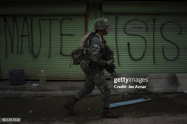 Philippine Marines soldiers in a cleared street but are still in range of enemy sniper fire as they walk towards the main battle area on July 22,...