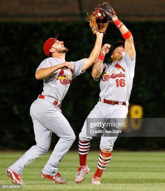 Kolten Wong of the St. Louis Cardinals collides with Paul DeJong but makes the catch for an out on a fly ball off the bat of Ben Zobrist of the...