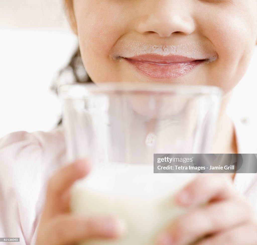 Girl holding glass of milk