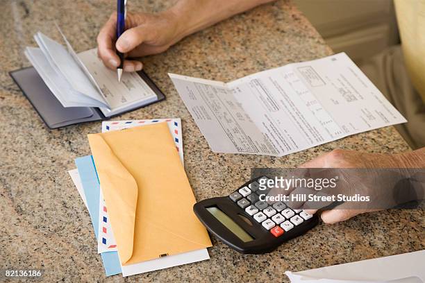 senior man paying bills - vitality stock pictures, royalty-free photos & images