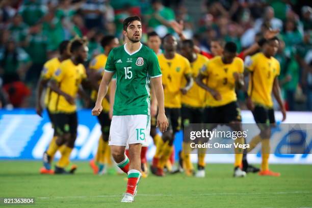 Rodolfo Pizarro of Mexico looks on as players of Jamaica celebrate after qualifying to the final during a match between Mexico and Jamaica as part of...