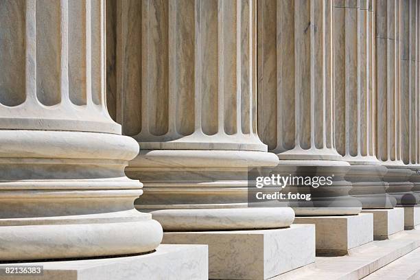 row of stone columns - financial strength stock pictures, royalty-free photos & images