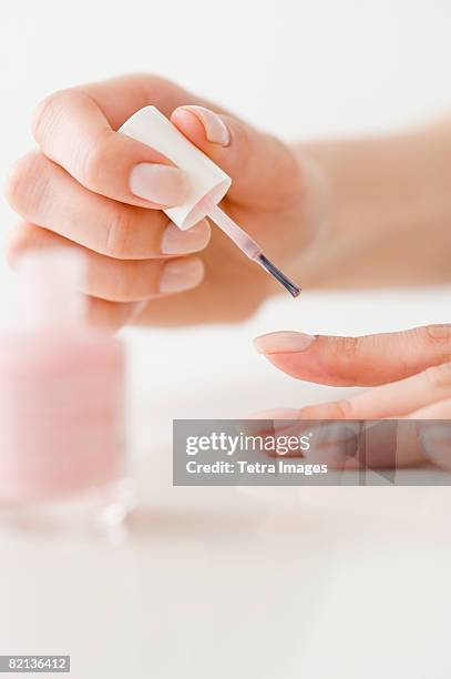 woman painting fingernails - painting fingernails stock pictures, royalty-free photos & images