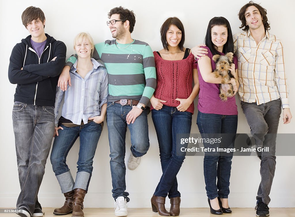 Group of friends leaning on wall