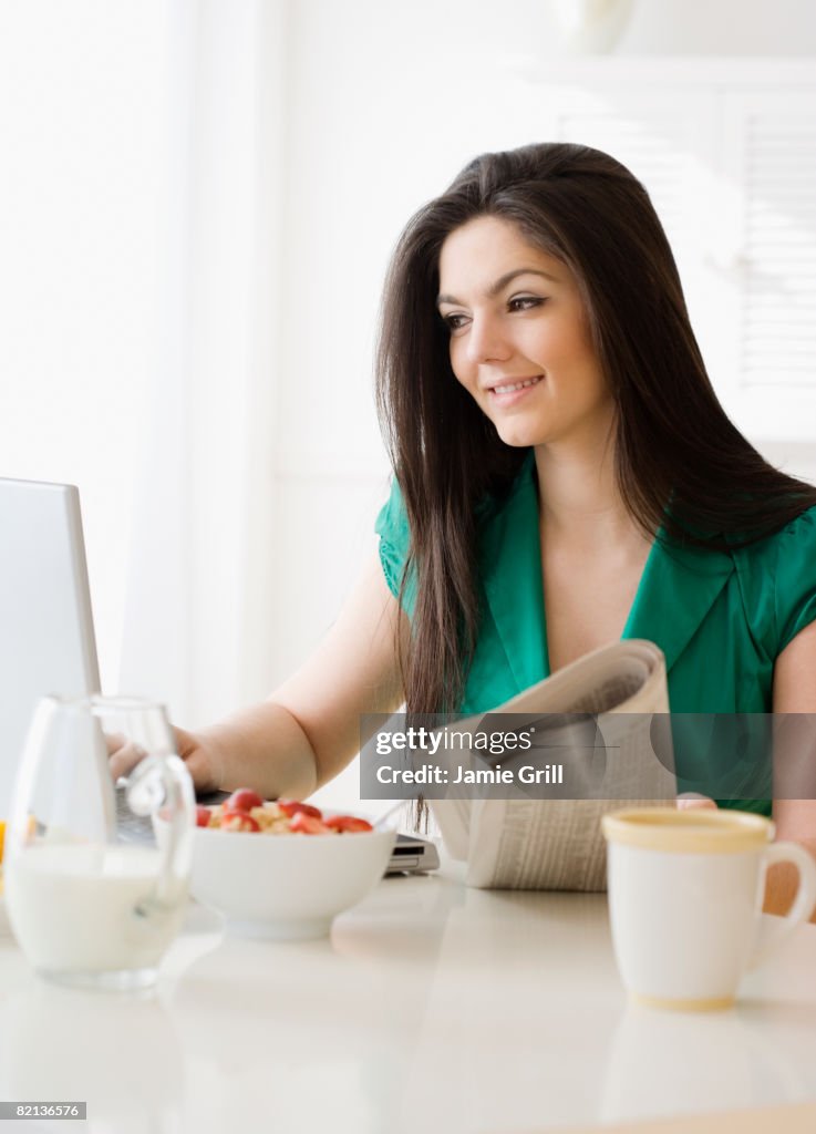 Woman looking at laptop in morning