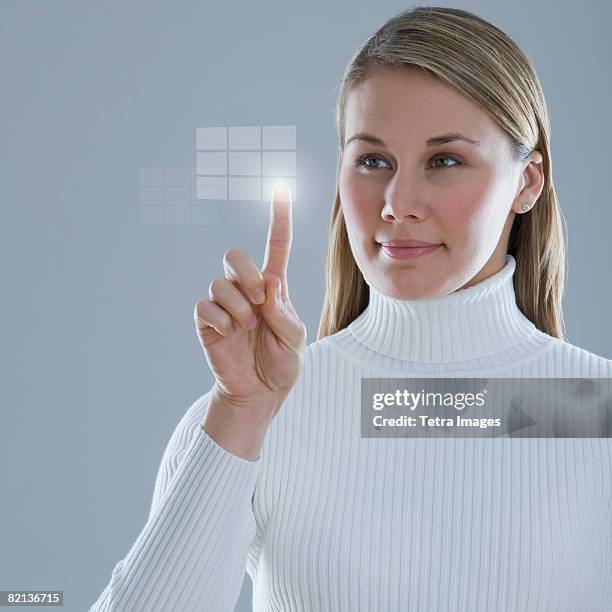 woman touching lighted display - push pin stock-fotos und bilder