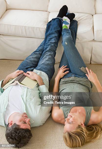 couple with feet up on sofa - playing footsie stock pictures, royalty-free photos & images